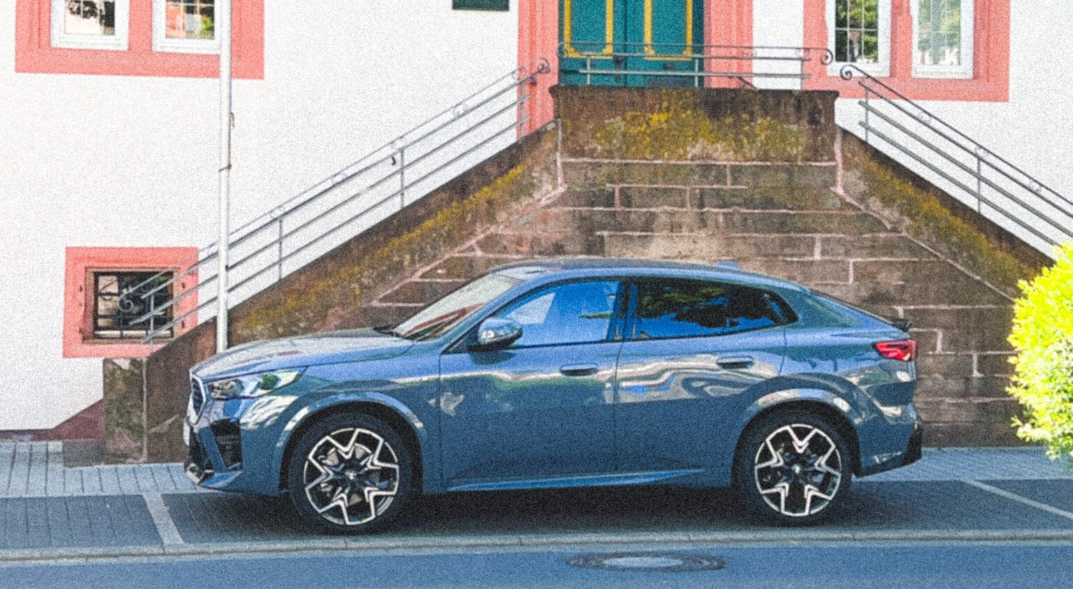 2026 BMW X2 with Cybex stroller in boot and infant car seat installed, showing compact luxury SUV as a practical family car